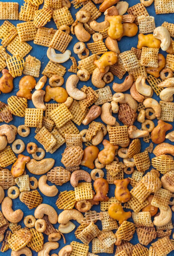 Overhead view of scattered cereal, pretzels, and nuts.