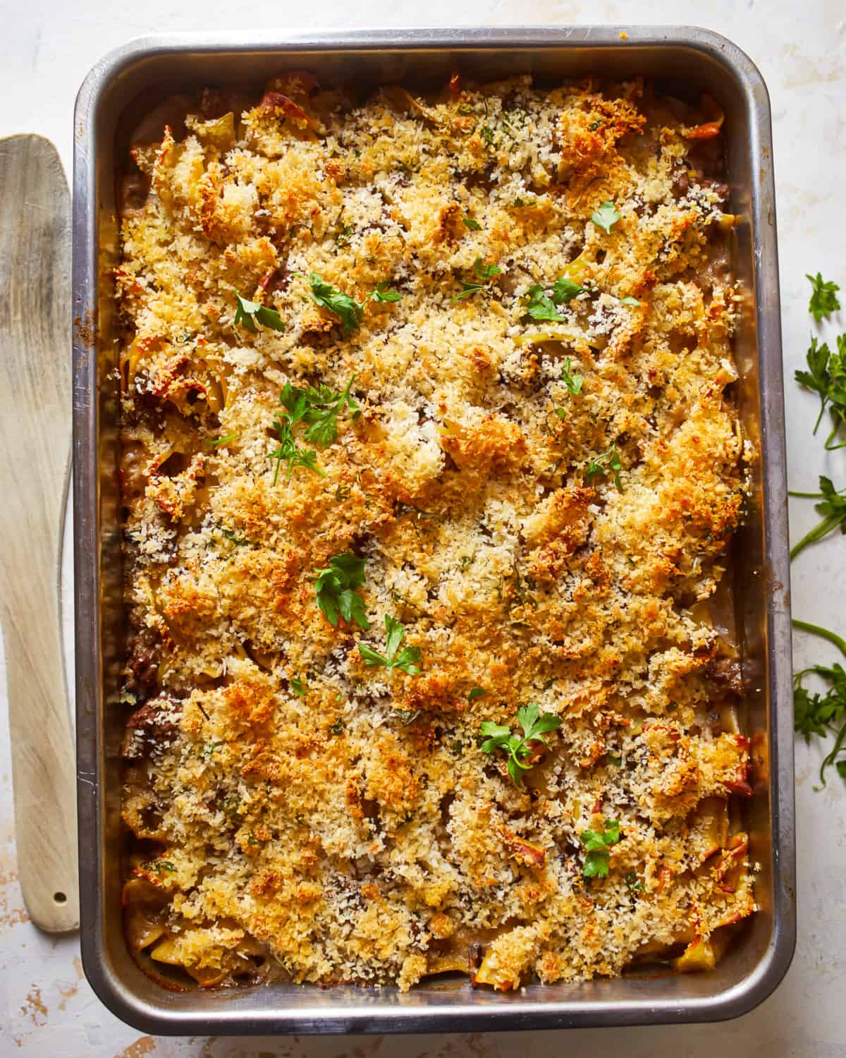 a baking dish filled with pasta and parmesan cheese.